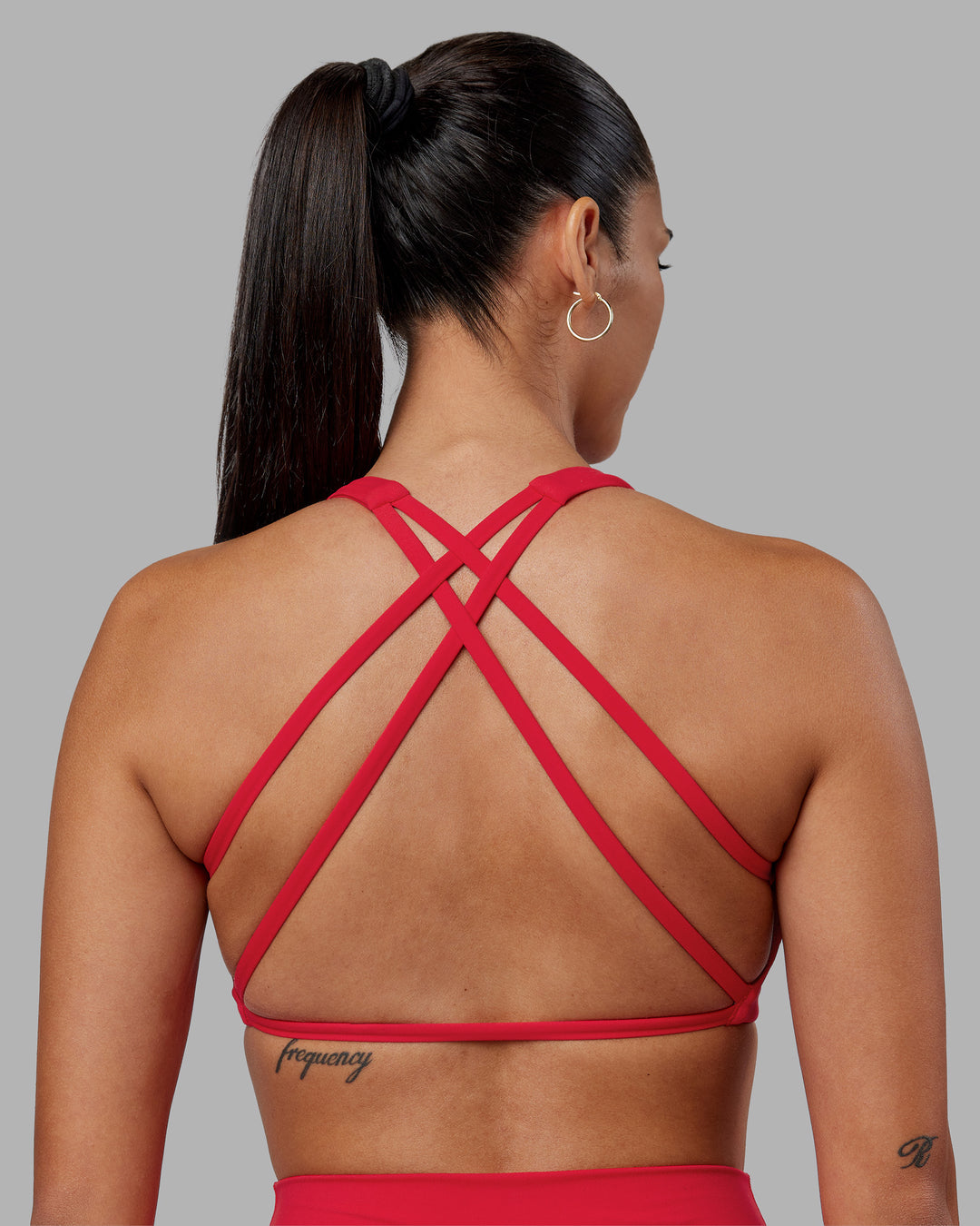 Woman wearing Aspire Sports Bra - Scarlet | Model:Rhiley | Size:S - view 1