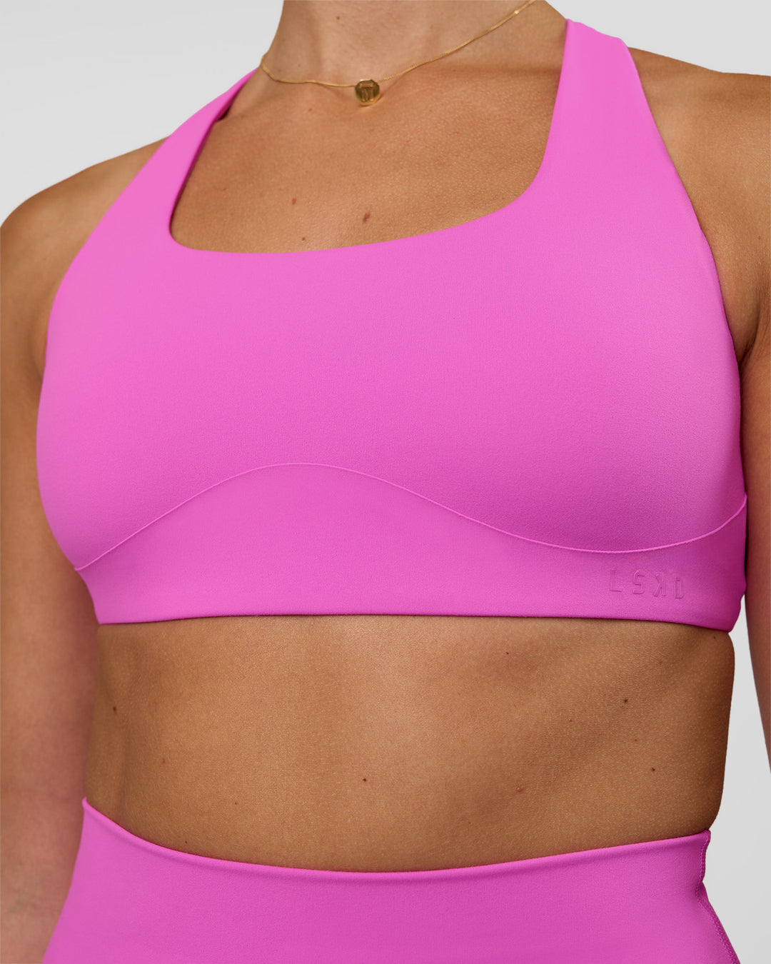 Woman wearing Aspire Sports Bra - Ultra Fuchsia | Model:Myrte | SIze:S - view 4