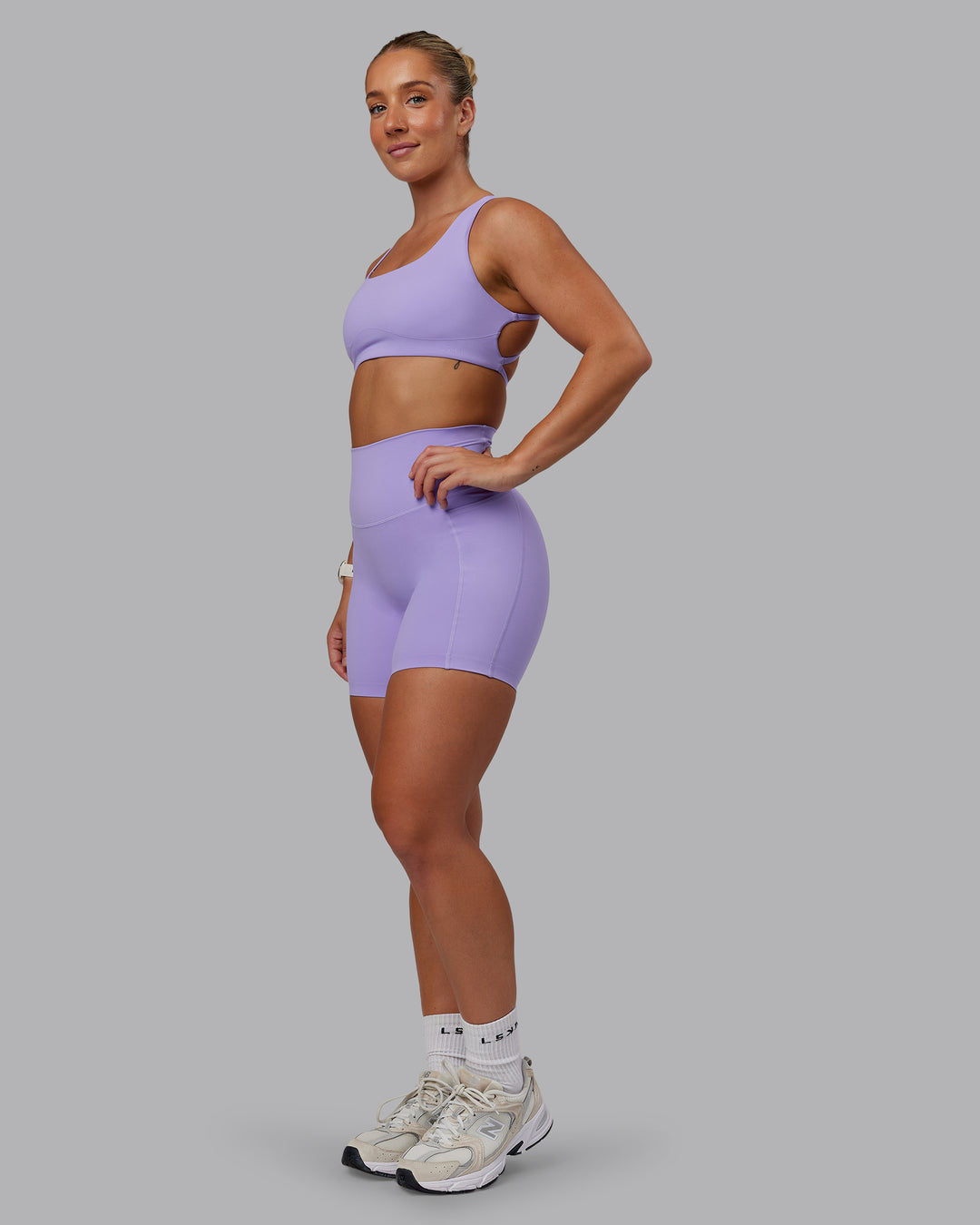 Woman wearing Aspire Sports Bra in Violet Ray | Size:S - view 3
