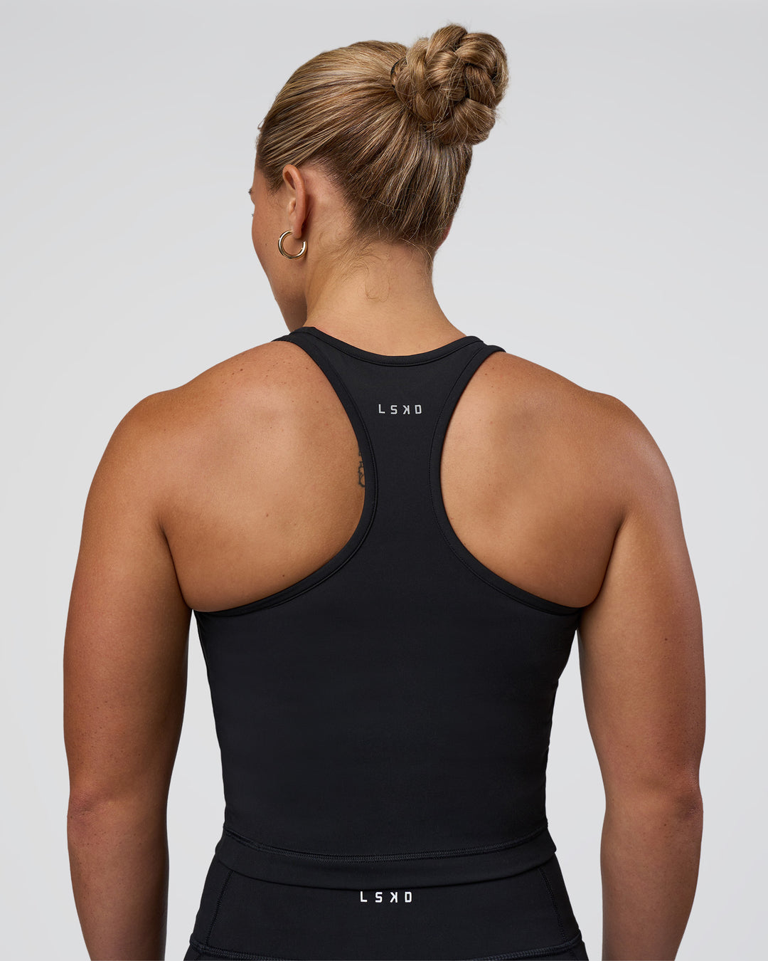 Woman wearing Be Bold Performance Tank - Black | Model:Tenaya | Size:S - view 3