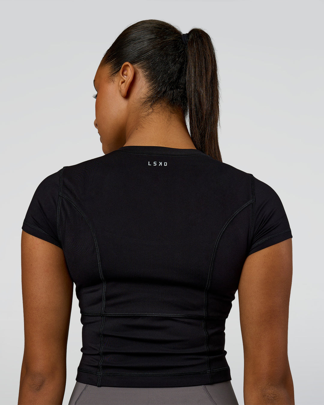 Woman wearing Bend Performance Tee - Black | Model:Rosie | Size:S - view 4
