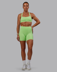 Woman wearing Bree Masters Fusion Ultra High-Rise 6" Short Pockets - Pastel Lime | Thumbnail Index: 10