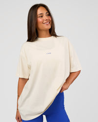 Woman wearing Built On Values Oversized Washed Tee - Off White Washed-Electric Indigo | Model:Bianca | Size:S | Thumbnail Index: 1