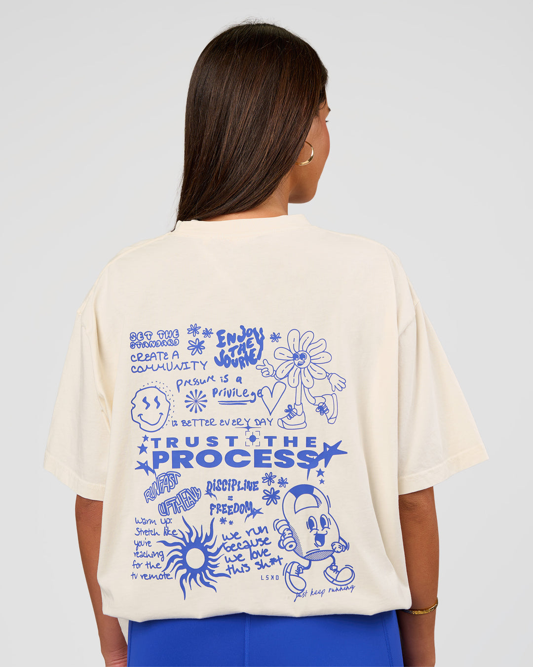 Woman wearing Built On Values Oversized Washed Tee - Off White Washed-Electric Indigo | Model:Bianca | Size:S - view 1