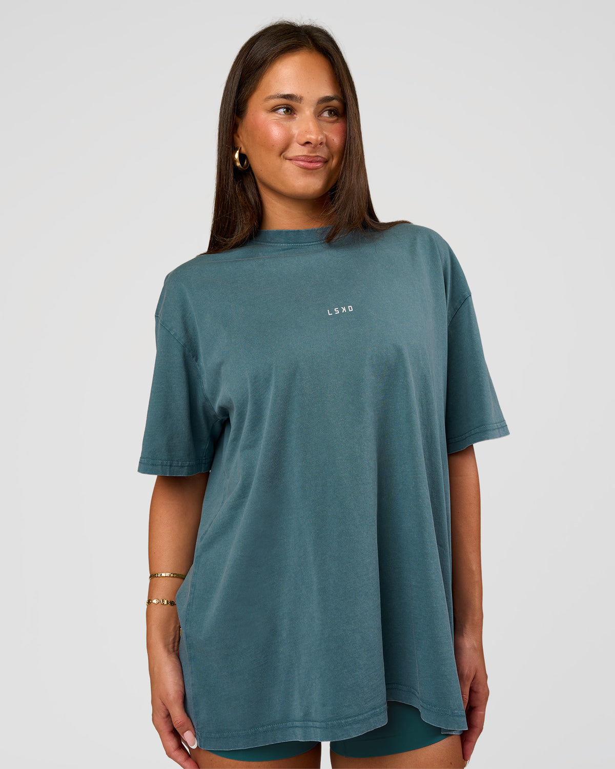 Woman wearing Built On Values Oversized Washed Tee - Transformative Teal Washed-White | Model:Bianca | Size:S