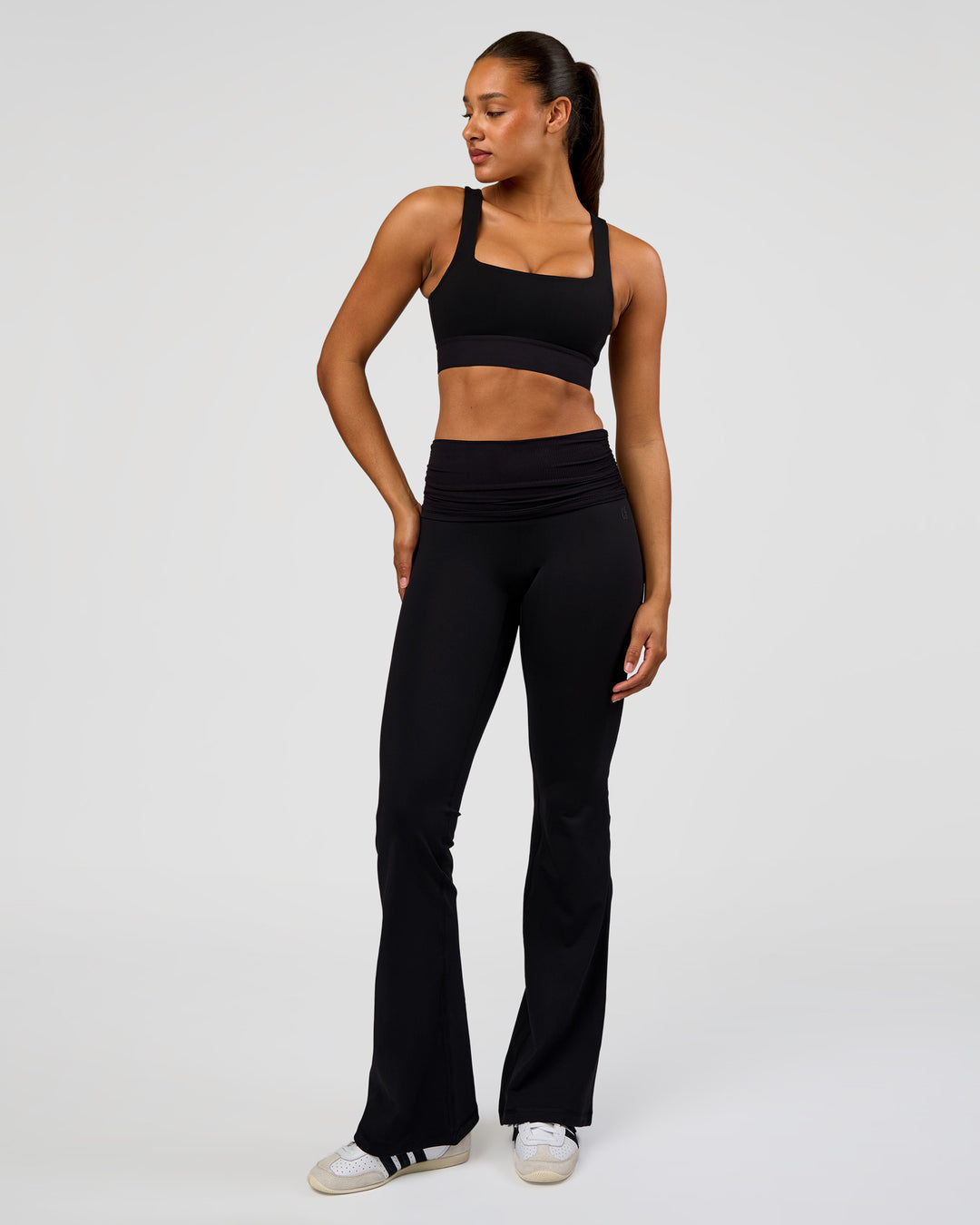 Woman wearing CF Fold Over High-Rise Flared Legging Tall - Black | Model:Rosie | Size:S - view 1