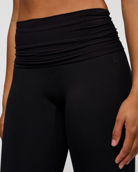Woman wearing CF Fold Over High-Rise Flared Legging Tall - Black | Model:Rosie | Size:S | Thumbnail Index: 1