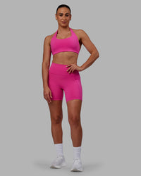 Woman wearing Challenger Sports Bra - Fuchsia Pink | Thumbnail Index: 1