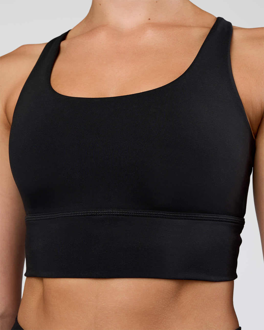 Woman wearing Circuit Longline Sports Bra - Black | Model:Evie | Size:S - view 4