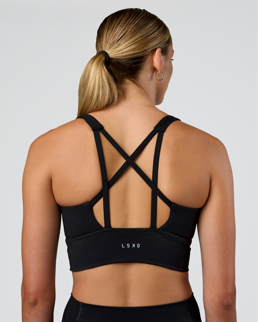 Woman wearing Circuit Longline Sports Bra - Black | Model:Evie | Size:S - view 2
