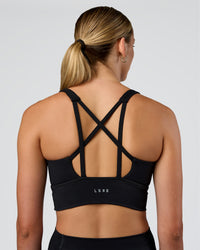 Woman wearing Circuit Longline Sports Bra - Black | Model:Evie | Size:S | Thumbnail Index: 1