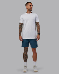 Man wearing Daily 7" Shorts - Indigo | Thumbnail Index: 4