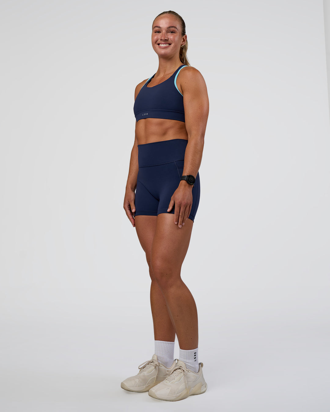 Woman wearing Distinction Sports Bra 2.0 - Future Navy-Baltic Sea | Model:Sav | Size:S - view 7
