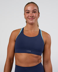 Woman wearing Distinction Sports Bra 2.0 - Future Navy-Baltic Sea | Model:Sav | Size:S | Thumbnail Index: 1