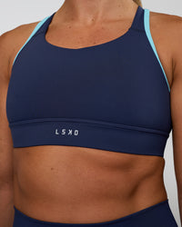 Woman wearing Distinction Sports Bra 2.0 - Future Navy-Baltic Sea | Model:Sav | Size:S | Thumbnail Index: 7