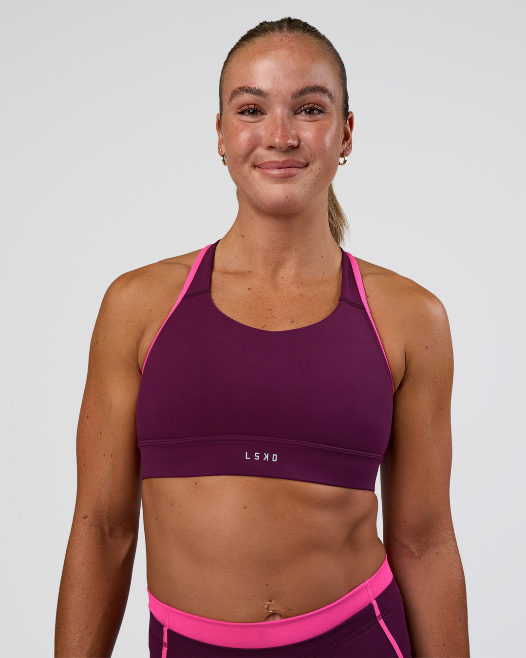 Woman wearing Distinction Sports Bra 2.0 - Plum Caspia-Ultra Pink | Model:Sav | Size:S - view 1