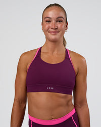 Woman wearing Distinction Sports Bra 2.0 - Plum Caspia-Ultra Pink | Model:Sav | Size:S | Thumbnail Index: 0