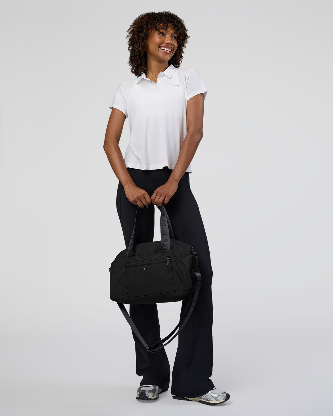 Woman wearing Drive Polo - White | Model:Tomi | Size:S - view 2