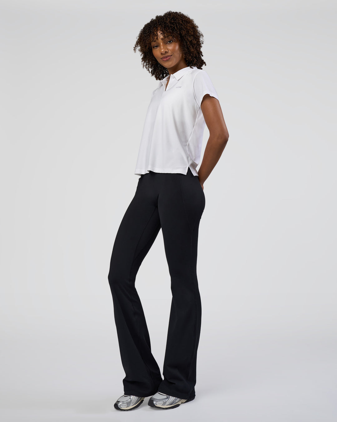 Woman wearing Drive Polo - White | Model:Tomi | Size:S - view 8