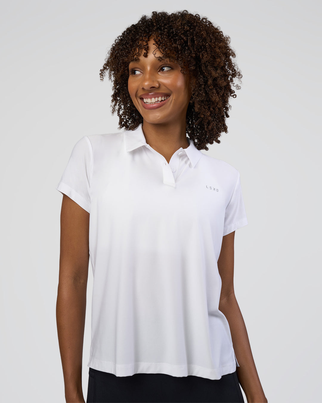 Woman wearing Drive Polo - White | Model:Tomi | Size:S - view 1