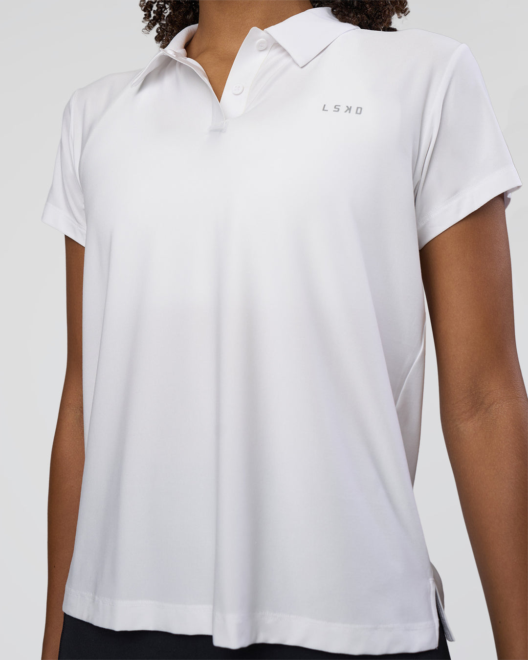 Woman wearing Drive Polo - White | Model:Tomi | Size:S - view 7