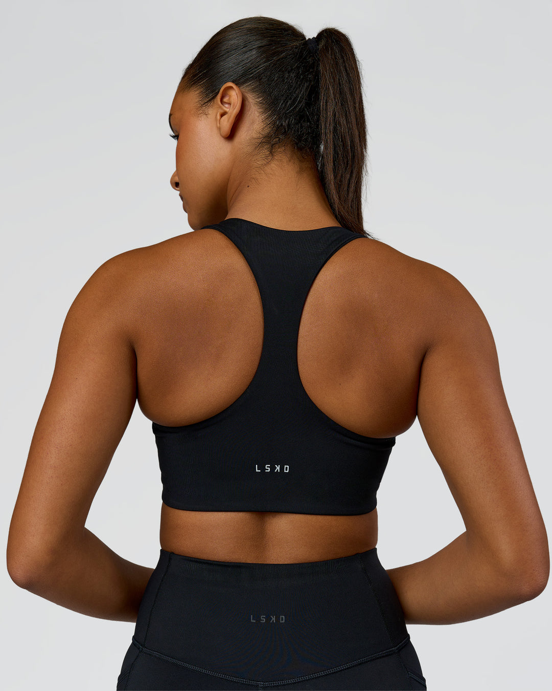 Woman wearing Elarra Zip Front Sports Bra - Black | Model:Rosie | Size:S - view 3