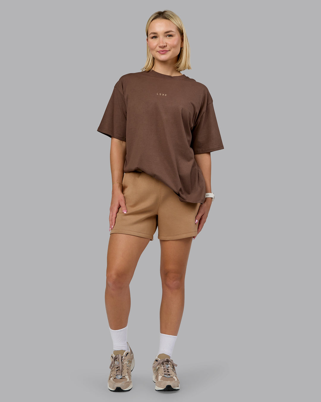 Woman wearing Elevate SoftTouch 4" Short - Light Taupe | Model:Halle | Size:S - view 2