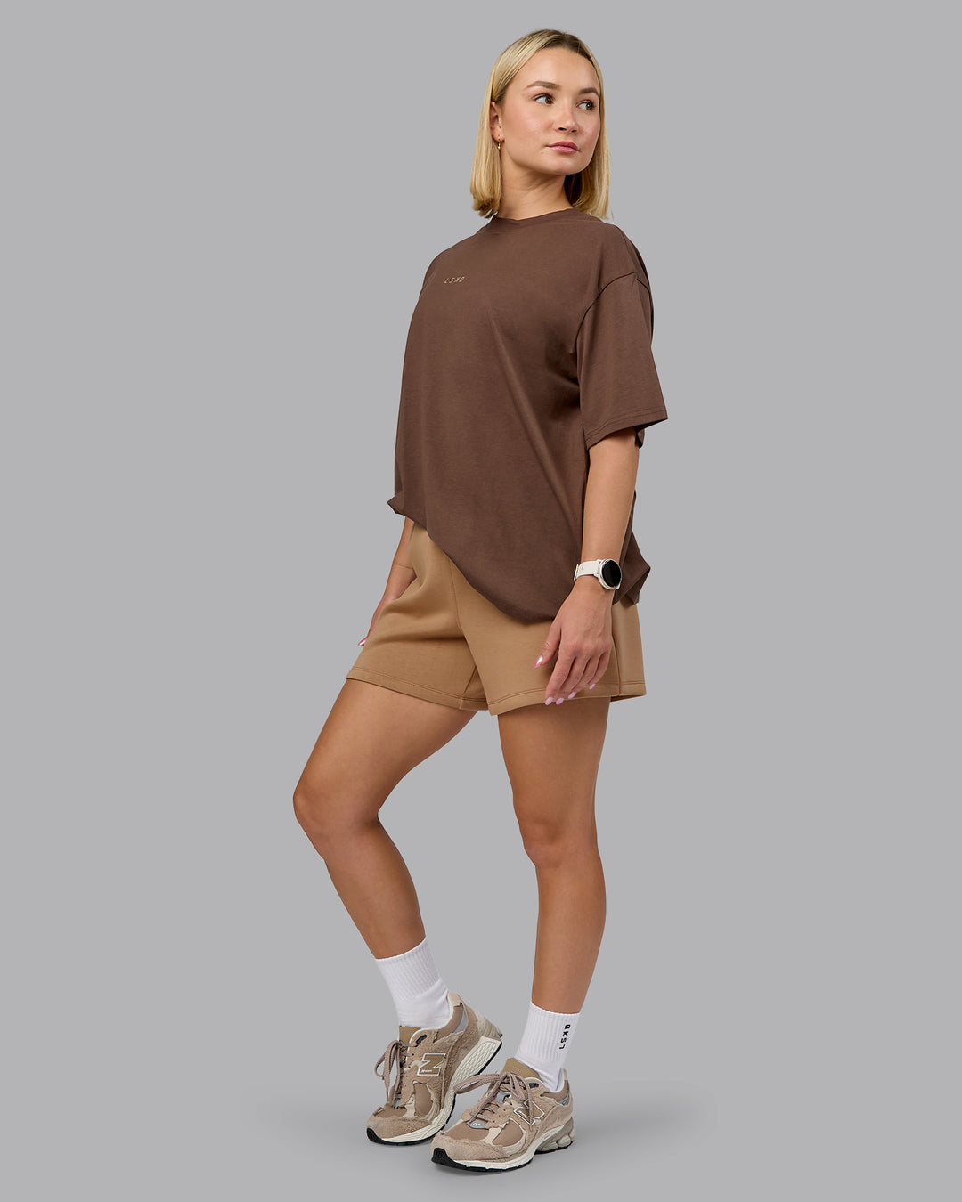 Woman wearing Elevate SoftTouch 4" Short - Light Taupe | Model:Halle | Size:S - view 5
