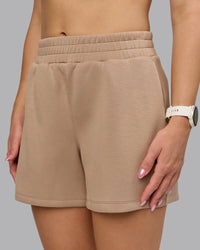 Woman wearing Elevate SoftTouch 4" Short - Light Taupe | Model:Halle | Size:S | Thumbnail Index: 0