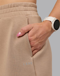 Woman wearing Elevate SoftTouch 4" Short - Light Taupe | Model:Halle | Size:S | Thumbnail Index: 6