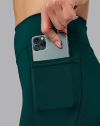 Woman wearing Elite High-Rise Full Length Legging Pockets - Dark Moss | Model:Halle | Size:S | Thumbnail Index: 2