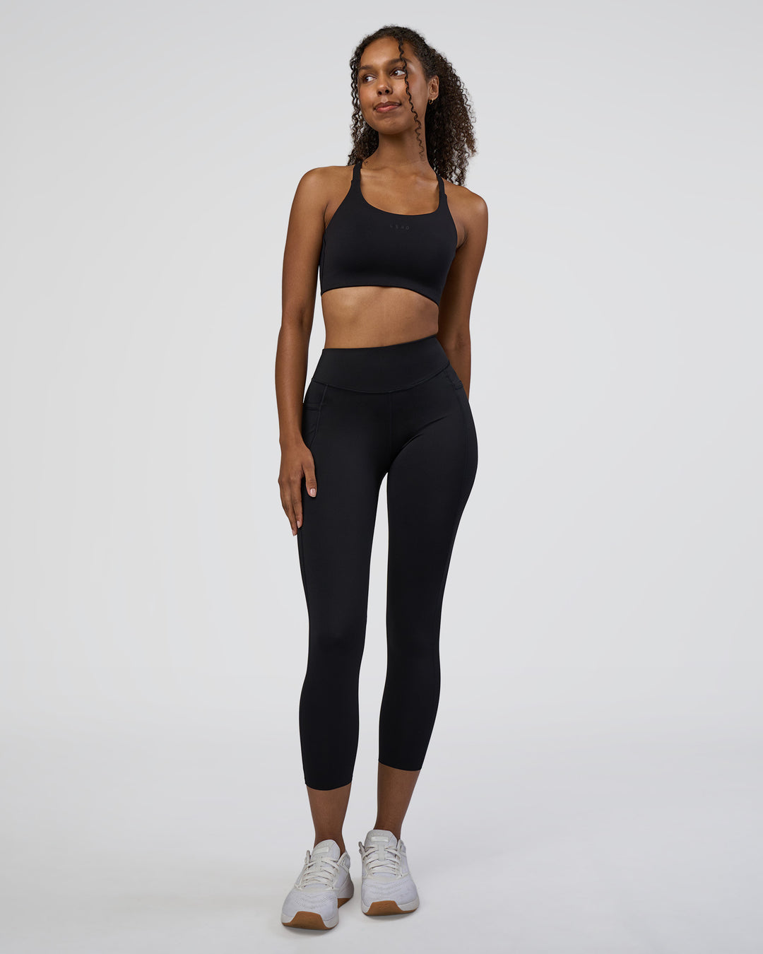 Woman wearing Elite High-Rise 7/8 Legging Pockets - Black | Model:Jordan | Size:S - view 1