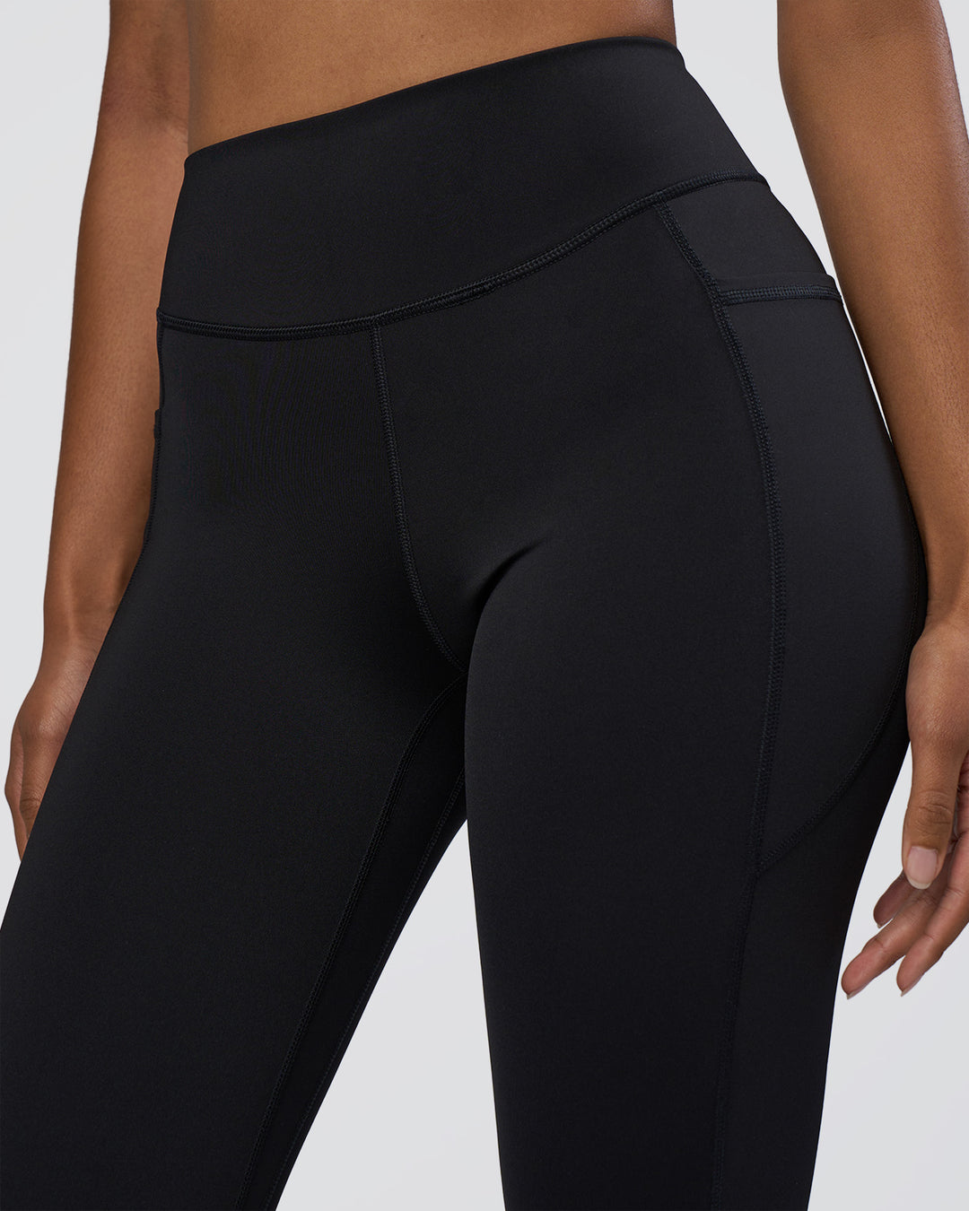 Woman wearing Elite High-Rise 7/8 Legging Pockets - Black | Model:Jordan | Size:S - view 3