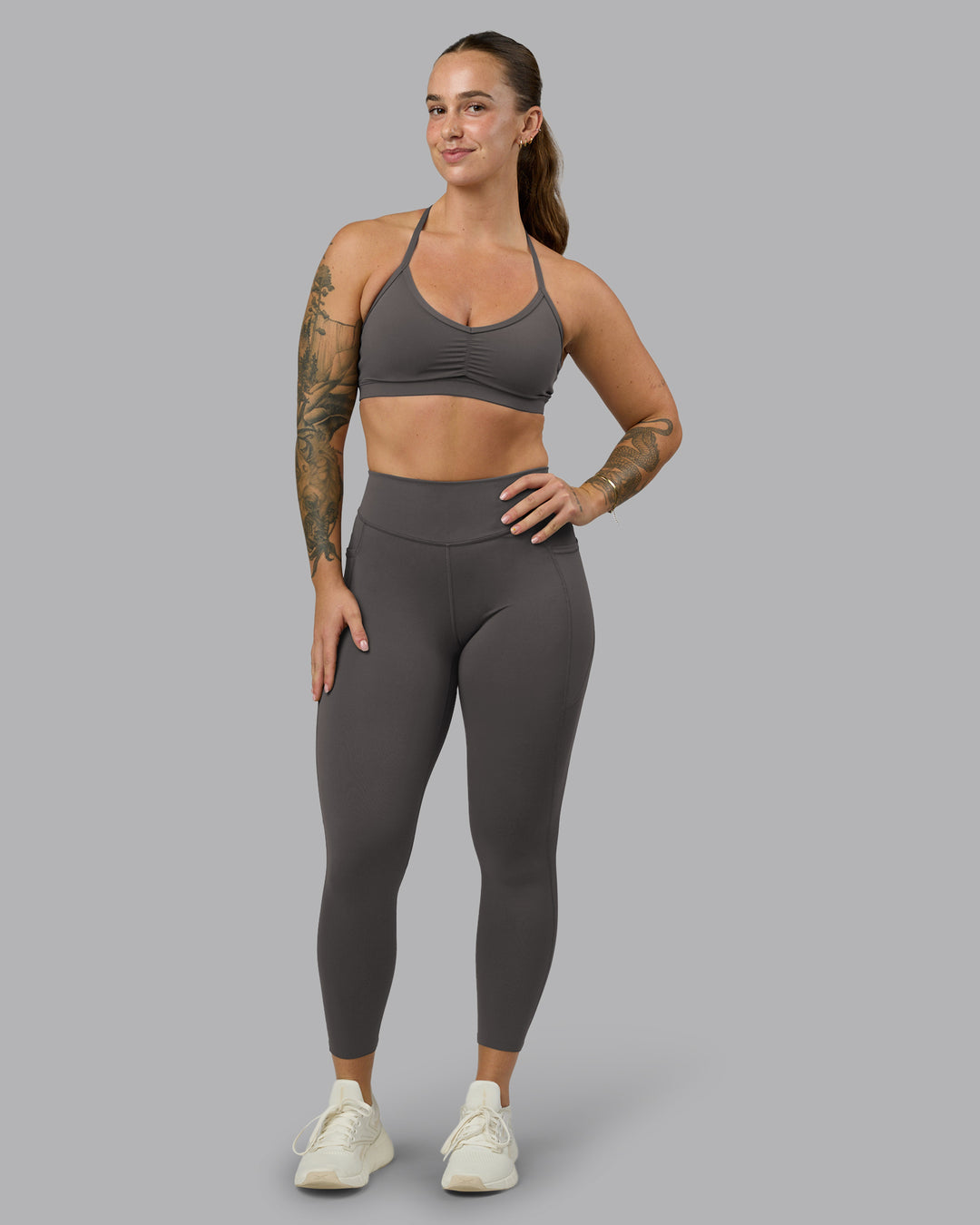 Woman wearing Elite High-Rise 7/8 Legging Pockets - Dark Storm | Model:Robyn | Size:S - view 1