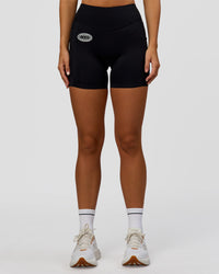 Woman wearing Elite Hype Reflective Run High-Rise 5" Short Pockets - Black-Hype Reflective | Model:Amity | Size:S | Thumbnail Index: 6