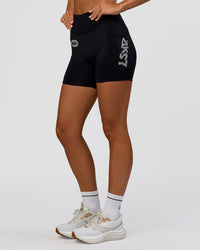 Woman wearing Elite Hype Reflective Run High-Rise 5" Short Pockets - Black-Hype Reflective | Model:Amity | Size:S | Thumbnail Index: 0