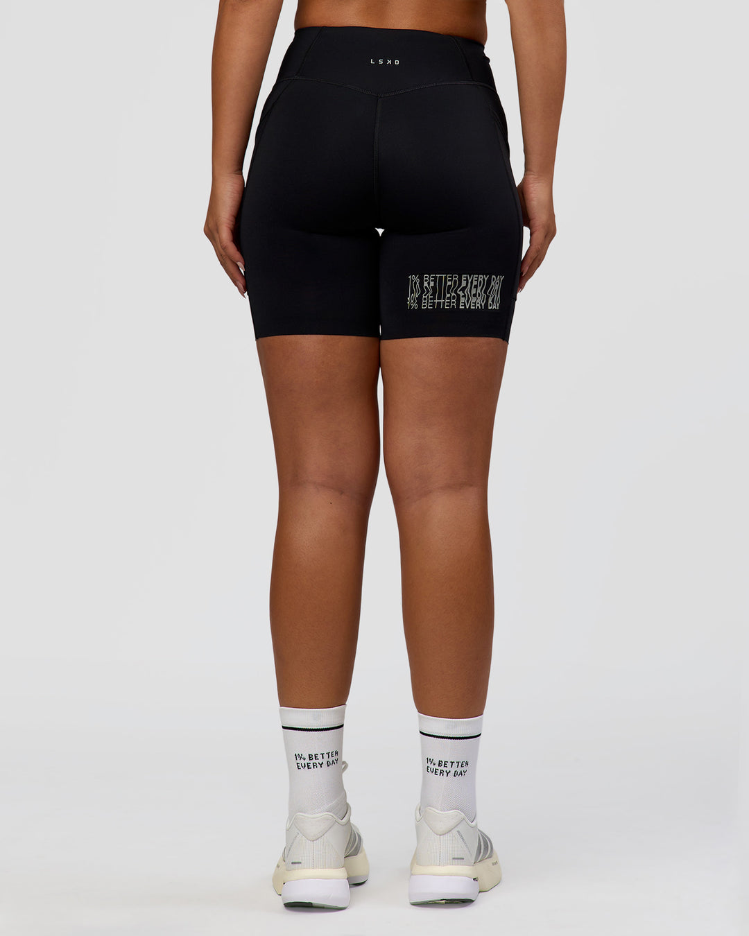 Woman wearing Elite Hype Reflective Run High-Rise 7" Short Pockets - Black-Hype Reflective | Model:Sophia | Size:S - view 5