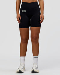 Woman wearing Elite Hype Reflective Run High-Rise 7" Short Pockets - Black-Hype Reflective | Model:Sophia | Size:S | Thumbnail Index: 1