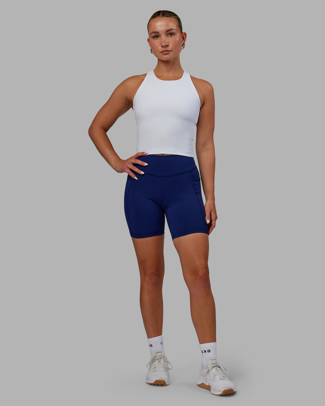 Woman wearing Elite High-Rise 6" Short Pockets - Midnight Blue - view 1