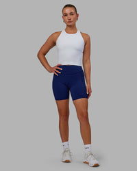 Woman wearing Elite High-Rise 6" Short Pockets - Midnight Blue | Thumbnail Index: 0