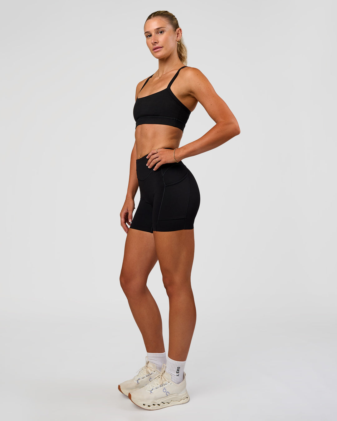 Woman wearing Elite Run High-Rise 5" Short Pockets - Black | Model:Emelia | Size:S - view 12