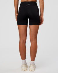 Woman wearing Elite Run High-Rise 5" Short Pockets - Black | Model:Emelia | Size:S | Thumbnail Index: 8