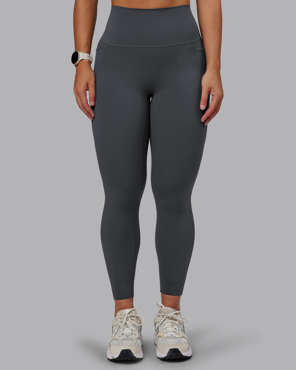 Woman wearing Elixir Ultra High-Rise 7/8 Legging Pockets - Dark Storm | Model:Lyss | Size:S