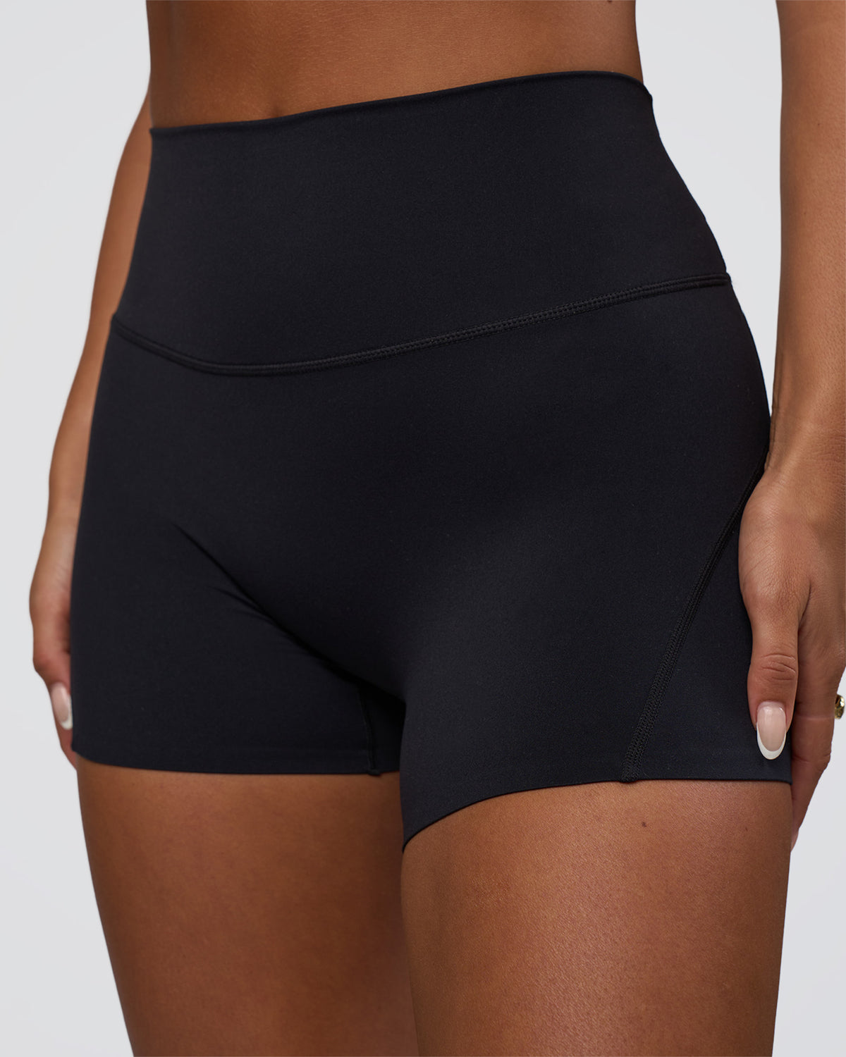 Woman wearing Elixir Defined High-Rise 4" Short Pockets - Black | Model:Bianca | Size:S