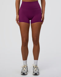Woman wearing Elixir Defined High-Rise 4" Short - Plum Caspia | Model:Bianca | Size:S | Thumbnail Index: 4