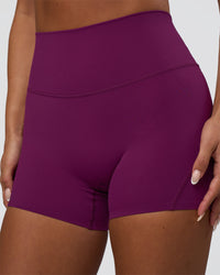 Woman wearing Elixir Defined High-Rise 4" Short - Plum Caspia | Model:Bianca | Size:S | Thumbnail Index: 1