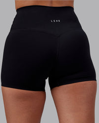 Woman wearing Elixir High-Rise 4" Short - Black | Model:Rhiley | Size:S | Thumbnail Index: 7