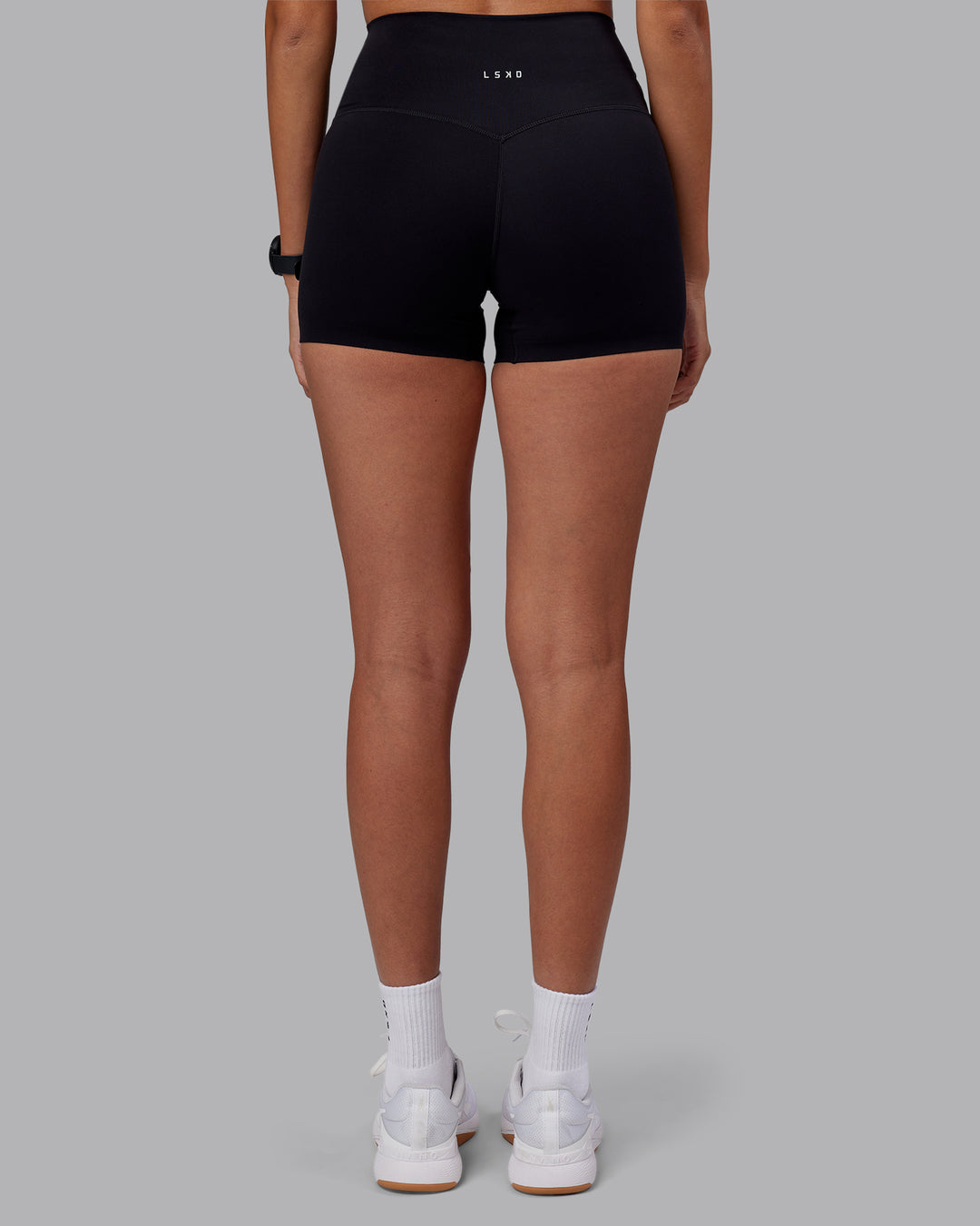 Woman wearing Elixir High-Rise 4" Short - Black | Model:Rhiley | Size:S - view 4