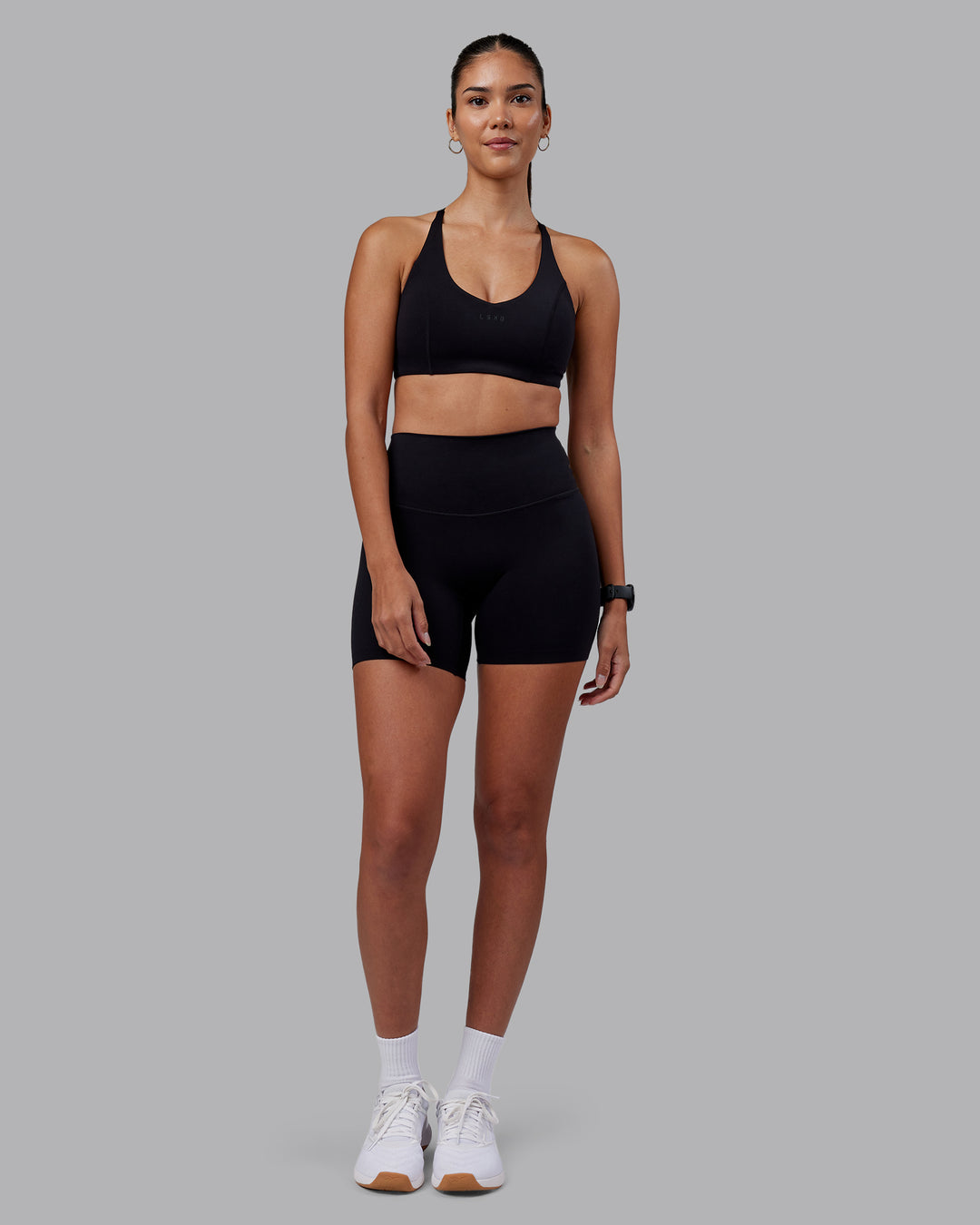 Woman wearing Elixir High-Rise 6" Short - Black | Model:Rhiley | Size:S - view 5