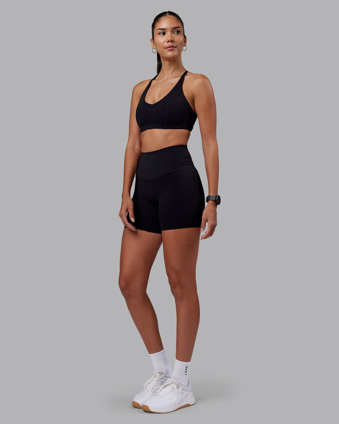 Woman wearing Elixir High-Rise 6" Short - Black | Model:Rhiley | Size:S - view 3